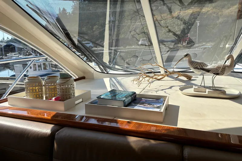 Dolce Far Niente Yacht Photos Pics Interior of 2012 Maritimo C53 Sports Cabriolet with decorative items and books on display.