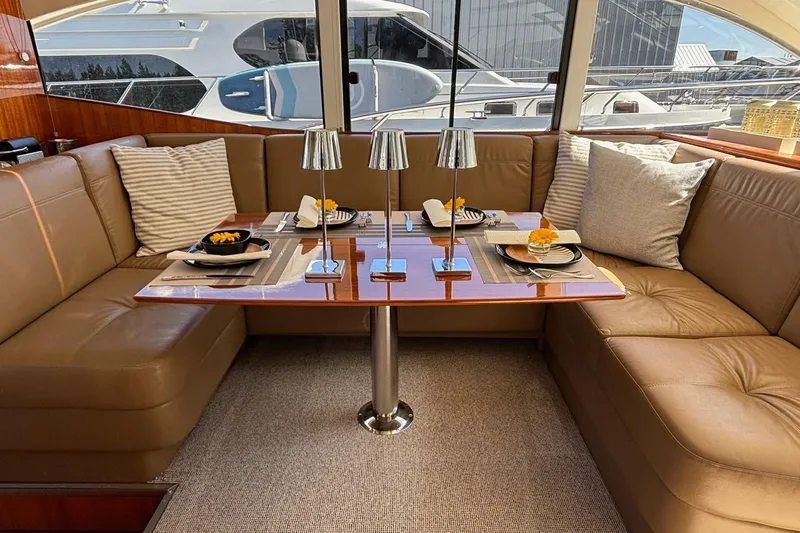 Dolce Far Niente Yacht Photos Pics Luxurious interior of 2012 Maritimo C53 Sports Cabriolet yacht with elegant dining setup.