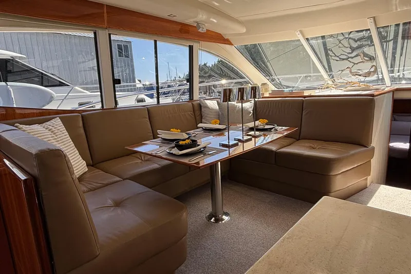 Dolce Far Niente Yacht Photos Pics Luxurious interior of 2012 Maritimo C53 Sports Cabriolet yacht with elegant dining area.