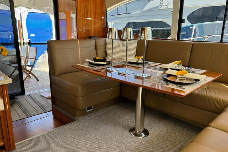 Dolce Far Niente Yacht Photos Pics Luxurious interior of 2012 Maritimo C53 Sports Cabriolet yacht with elegant dining setup.