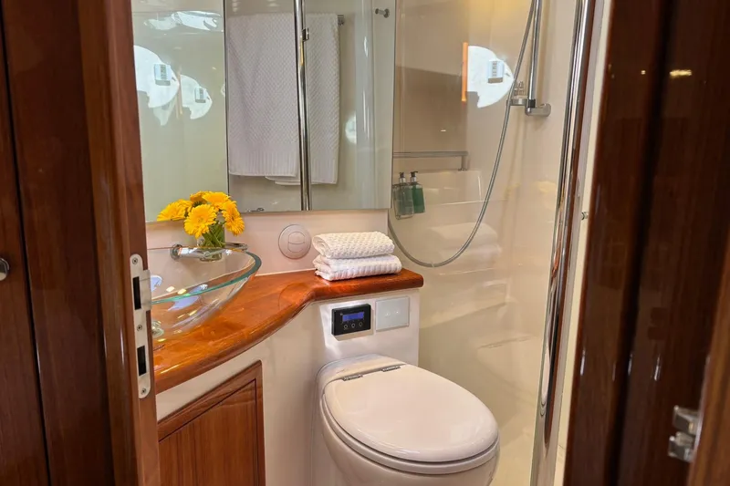 Dolce Far Niente Yacht Photos Pics Luxurious bathroom in 2012 Maritimo C53 Sports Cabriolet yacht with glass sink and shower.