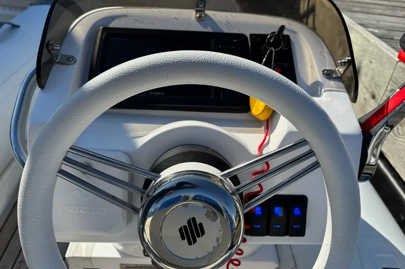Dolce Far Niente Yacht Photos Pics Steering wheel of a 2012 Maritimo C53 Sports Cabriolet boat with control panel.