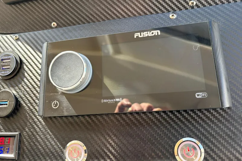 Dolce Far Niente Yacht Photos Pics Fusion audio system on 2012 Maritimo C53 Sports Cabriolet dashboard with carbon fiber finish.