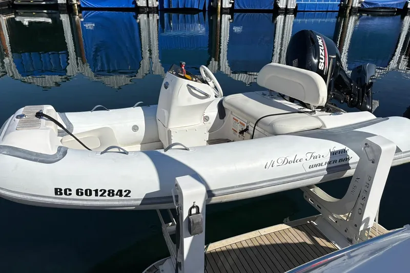 Dolce Far Niente Yacht Photos Pics Inflatable boat with Suzuki motor docked at marina, featuring registration number BC 6012842.