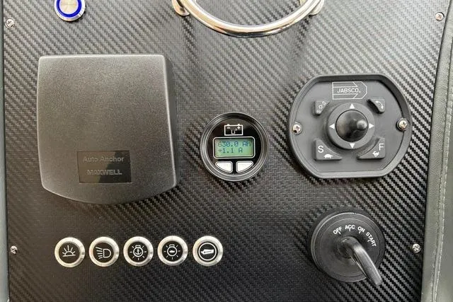 Dolce Far Niente Yacht Photos Pics Control panel of 2012 Maritimo C53 Sports Cabriolet with carbon fiber finish and various switches.