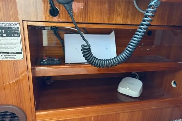 Dolce Far Niente Yacht Photos Pics 2012 Maritimo C53 Sports Cabriolet interior with communication equipment and wooden shelving.