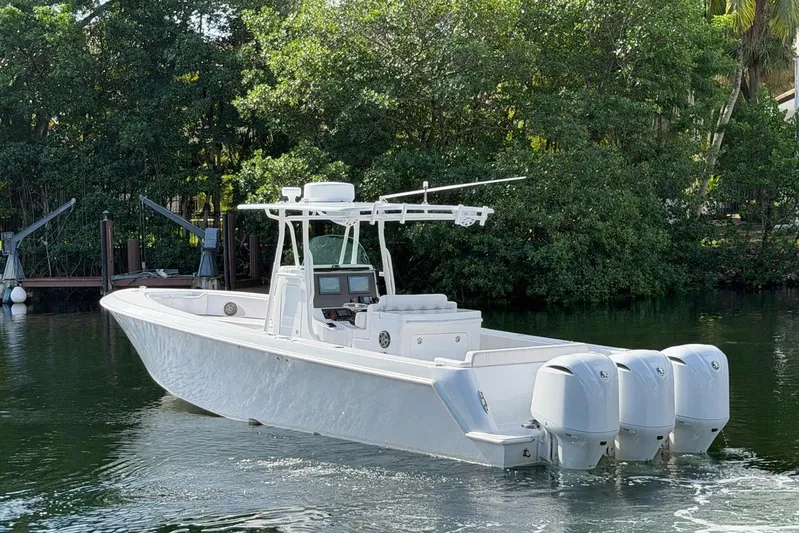  Yacht Photos Pics 2013 Contender 35 LS boat with triple engines on a calm waterway.