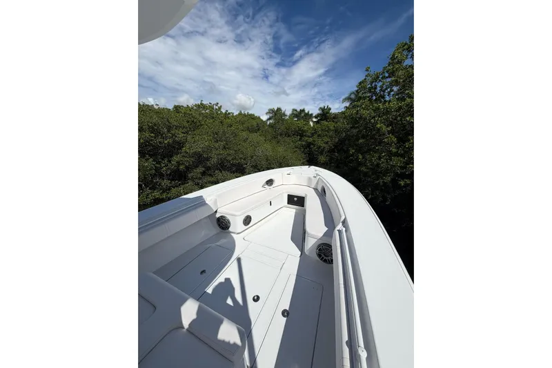  Yacht Photos Pics 2013 Contender 35 LS boat deck with lush greenery and blue sky background.