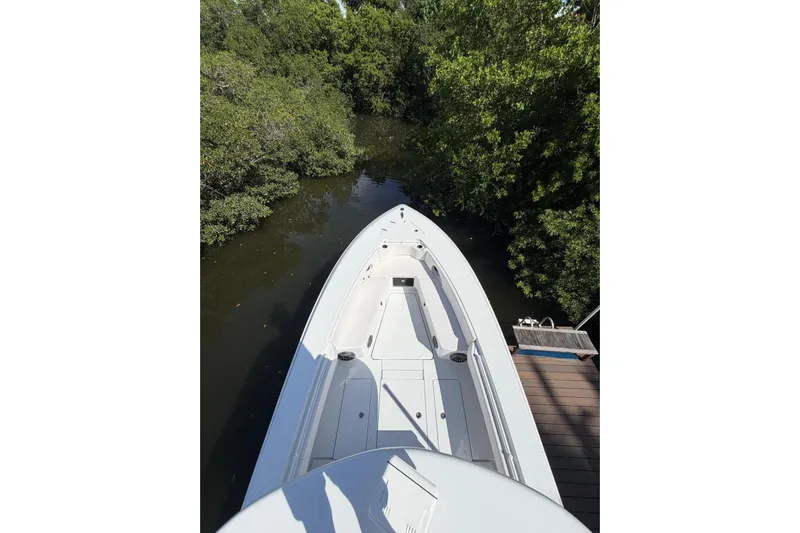  Yacht Photos Pics 2013 Contender 35 LS boat docked near lush green mangroves.