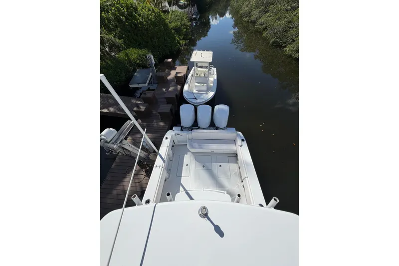  Yacht Photos Pics Overhead view of 2013 Contender 35 LS boat docked on a calm waterway.