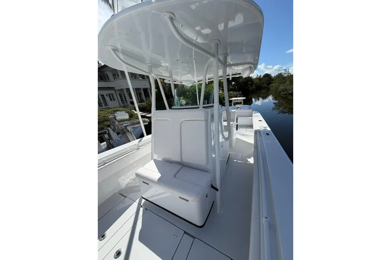  Yacht Photos Pics 2013 Contender 35 LS boat with sleek white interior and canopy on a calm waterway.