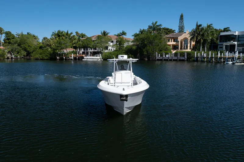 Yacht Photos Pics 2013 Contender 35 LS boat cruising on a serene waterway with lush greenery.