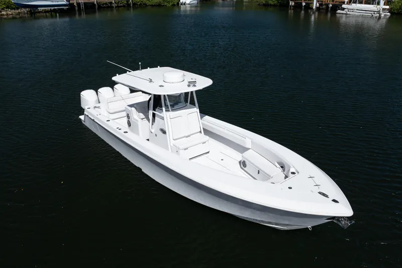  Yacht Photos Pics 2013 Contender 35 LS boat on calm water, showcasing sleek design and triple engines.