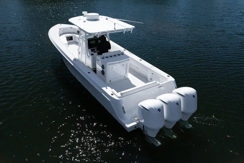  Yacht Photos Pics 2013 Contender 35 LS boat with triple outboard engines on calm water.