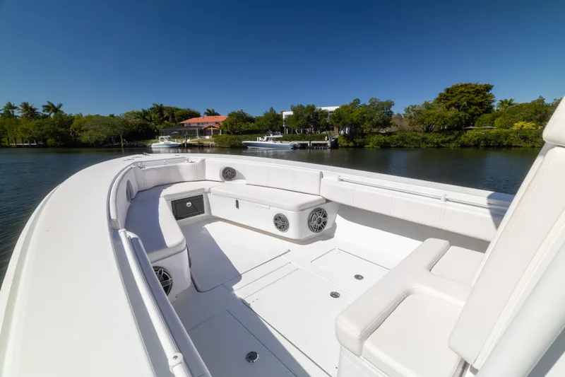  Yacht Photos Pics 2013 Contender 35 LS boat interior with white seating, speakers, and scenic waterfront view.