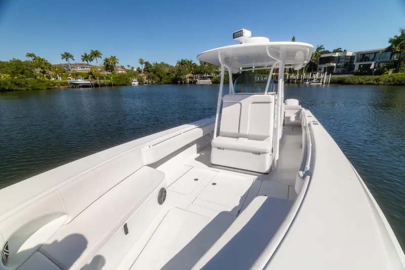  Yacht Photos Pics 2013 Contender 35 LS boat on calm water, featuring spacious seating and sleek design.