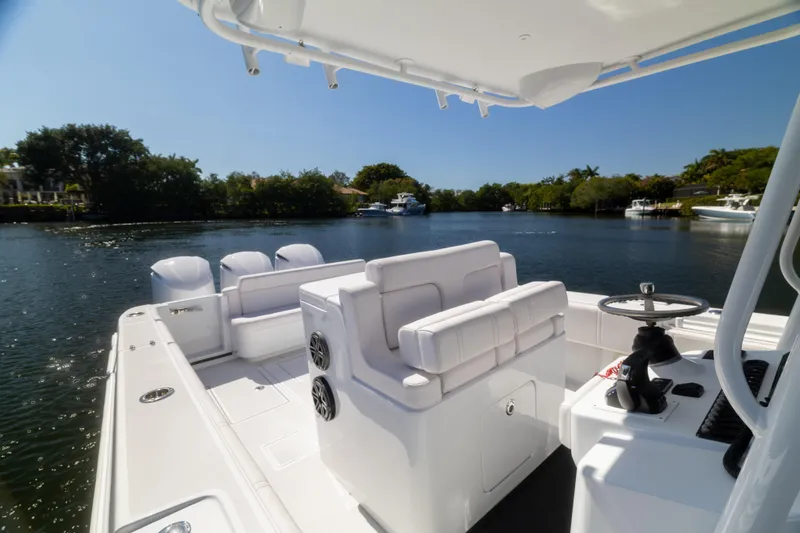  Yacht Photos Pics 2013 Contender 35 LS boat interior with seating and steering, on a calm waterway.