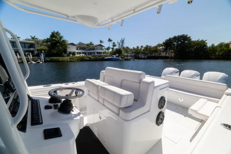  Yacht Photos Pics 2013 Contender 35 LS boat interior with steering wheel, seating, and waterfront view.