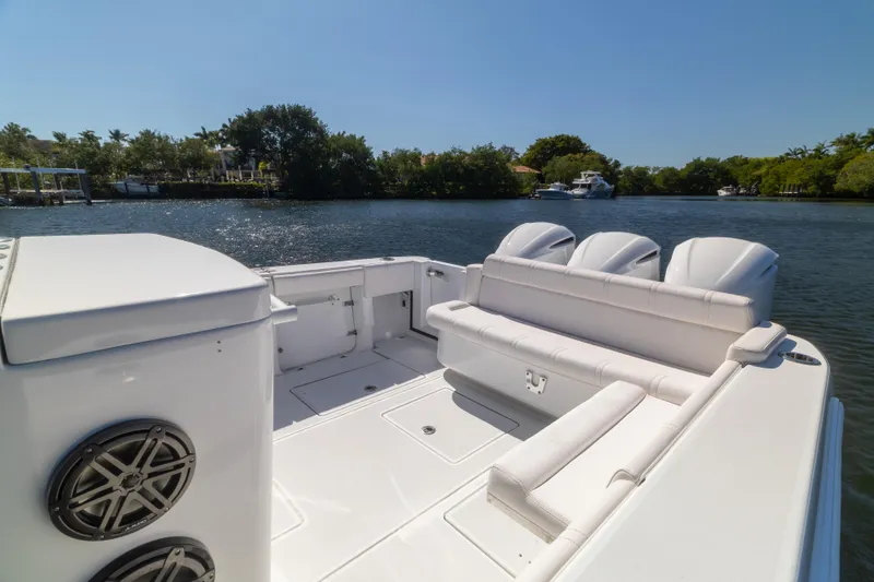 Yacht Photos Pics 2013 Contender 35 LS boat with white seating, docked on a sunny day by a river.