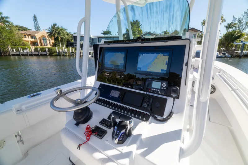 Yacht Photos Pics 2013 Contender 35 LS boat dashboard with navigation screens and steering wheel.