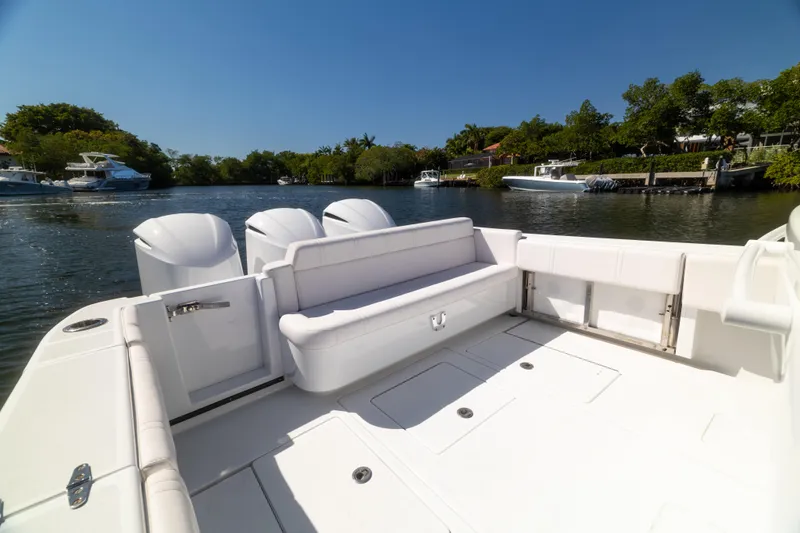  Yacht Photos Pics 2013 Contender 35 LS boat with spacious deck, triple engines, and scenic waterfront view.