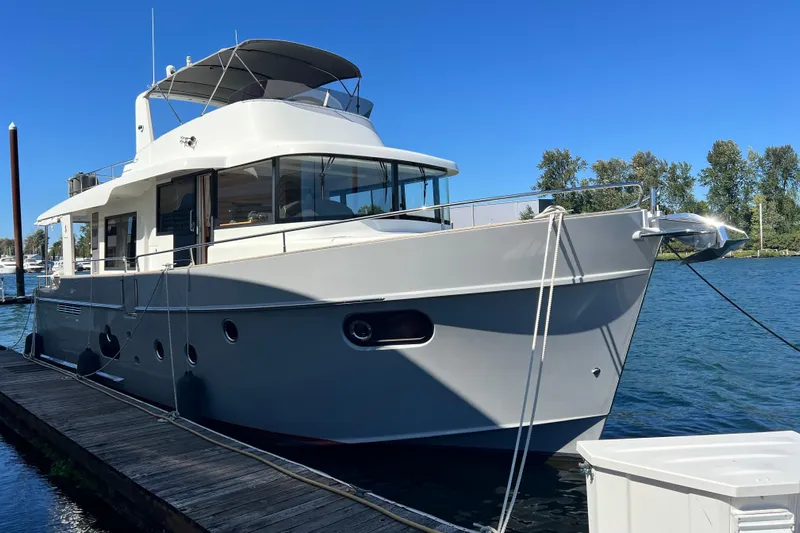 Billy Yacht Photos Pics 2014 Beneteau Swift Trawler 50 docked on a sunny day, showcasing sleek design and modern features.