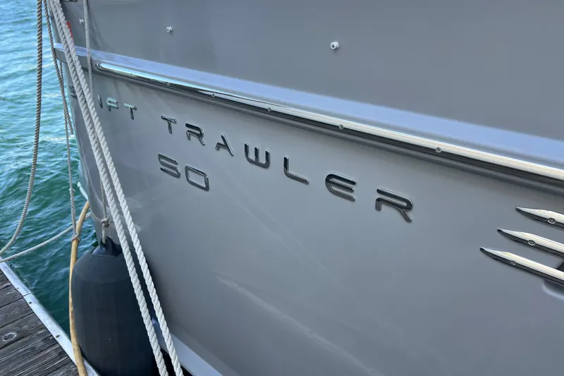Billy Yacht Photos Pics 2014 Beneteau Swift Trawler 50 docked, showcasing sleek design and branding.
