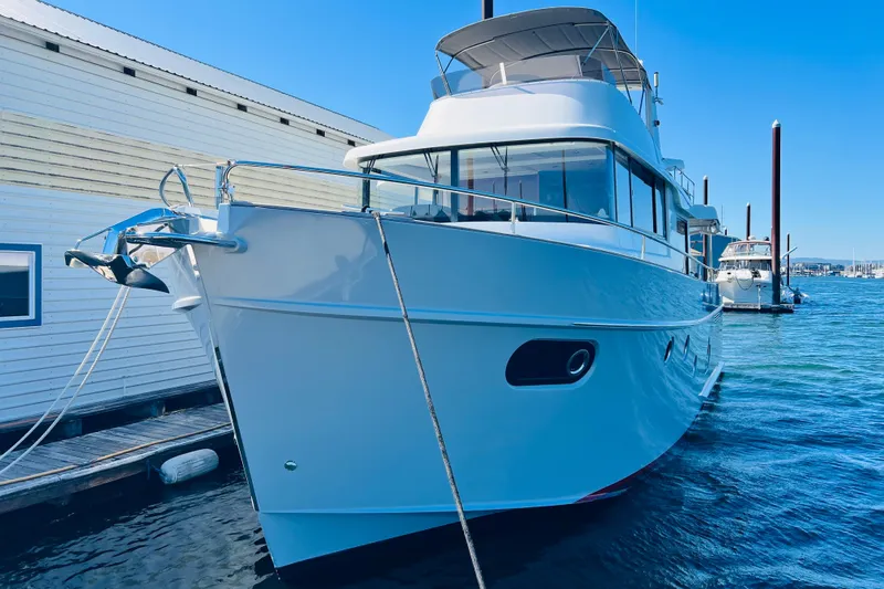 Billy Yacht Photos Pics 2014 Beneteau Swift Trawler 50 docked at marina, clear blue sky.