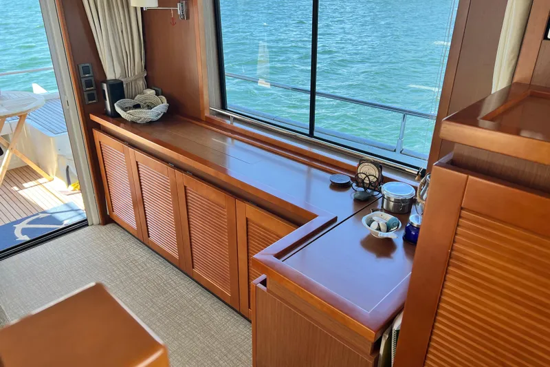 Billy Yacht Photos Pics Luxurious interior of 2014 Beneteau Swift Trawler 50 with wooden cabinetry and ocean view.
