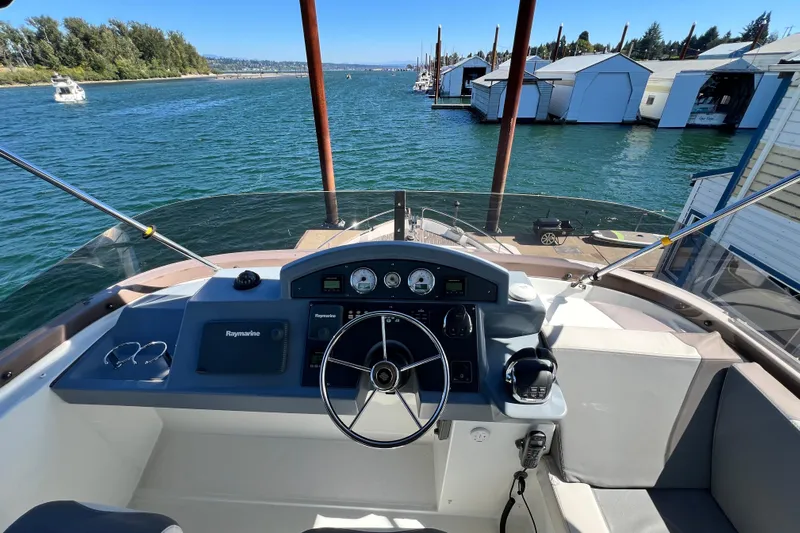 Billy Yacht Photos Pics 2014 Beneteau Swift Trawler 50 helm with Raymarine navigation, docked near marina.