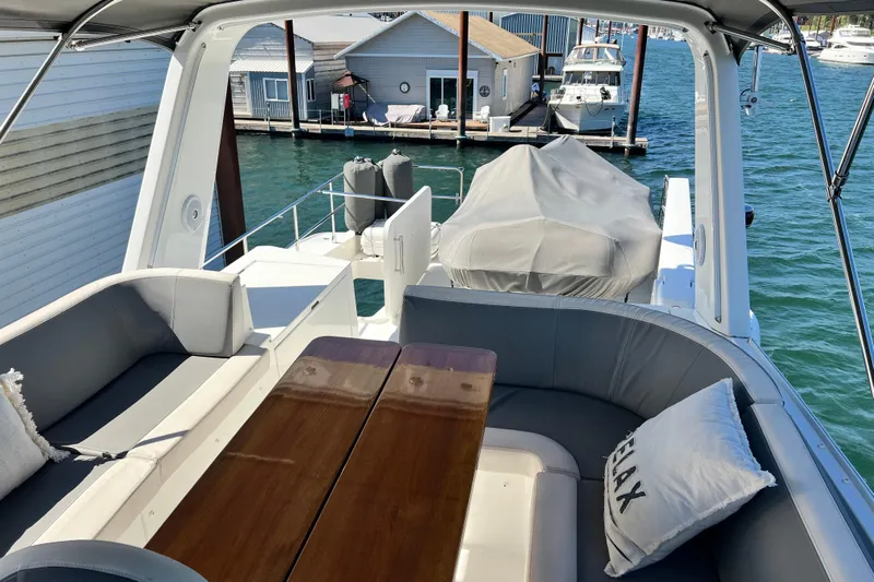 Billy Yacht Photos Pics 2014 Beneteau Swift Trawler 50 deck with seating, table, and marina view.