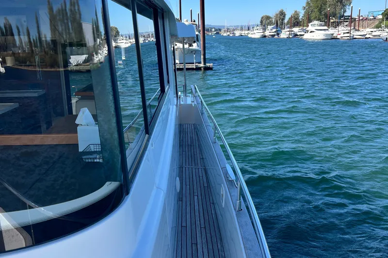 Billy Yacht Photos Pics 2014 Beneteau Swift Trawler 50 on water, docked near marina, clear blue sky.