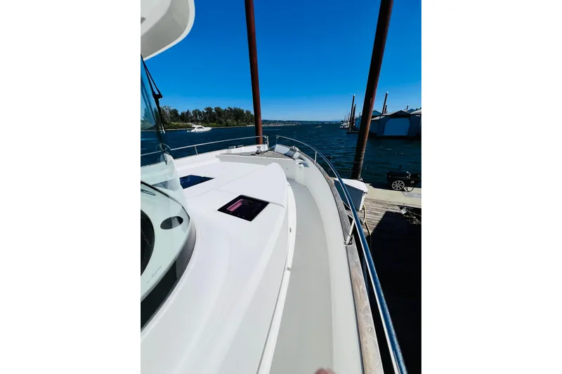 Billy Yacht Photos Pics 2014 Beneteau Swift Trawler 50 docked, showcasing sleek deck design and waterfront view.