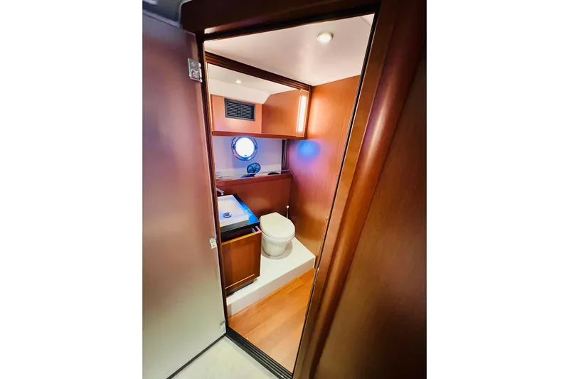 Billy Yacht Photos Pics 2014 Beneteau Swift Trawler 50 bathroom with wooden interior and modern fixtures.