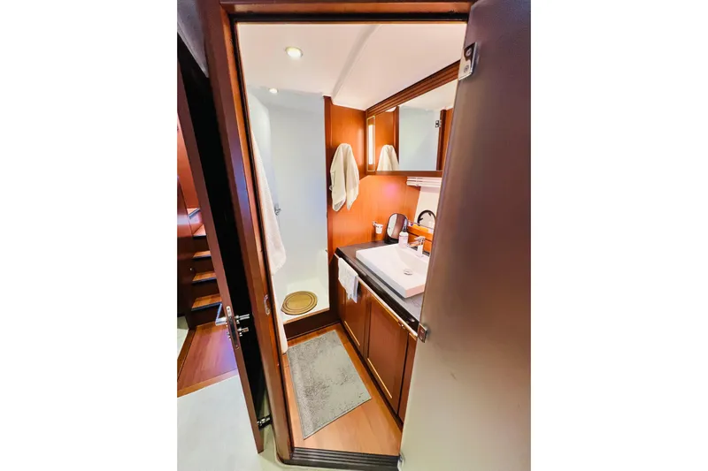 Billy Yacht Photos Pics 2014 Beneteau Swift Trawler 50 bathroom with wooden cabinetry and modern fixtures.