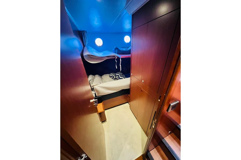 Billy Yacht Photos Pics Cozy cabin interior of 2014 Beneteau Swift Trawler 50 with bunk beds and wooden cabinetry.