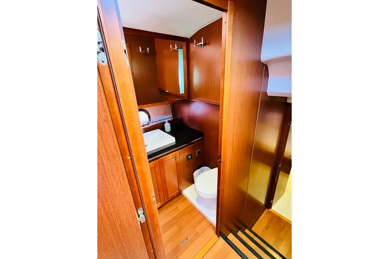 Billy Yacht Photos Pics 2014 Beneteau Swift Trawler 50 bathroom with wooden cabinetry and modern fixtures.