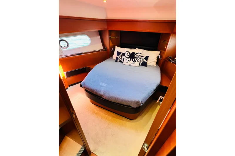 Billy Yacht Photos Pics Luxurious cabin interior of 2014 Beneteau Swift Trawler 50 with cozy bed and nautical decor.