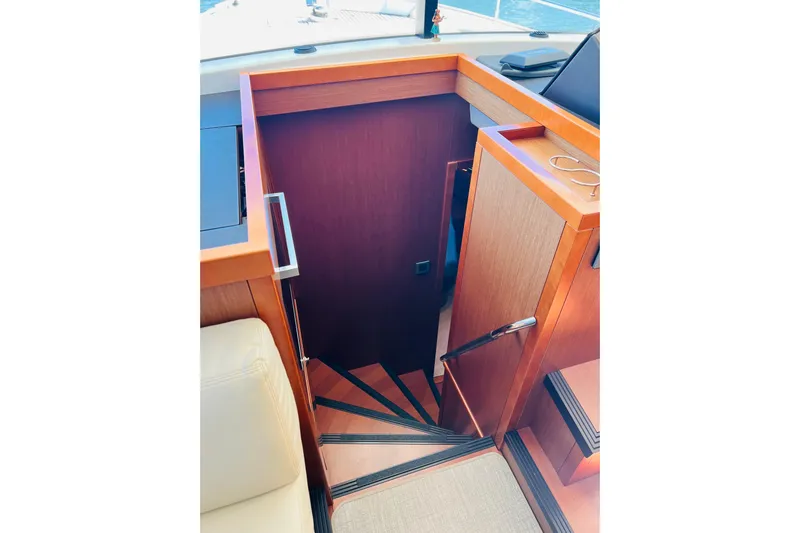 Billy Yacht Photos Pics Staircase on 2014 Beneteau Swift Trawler 50, leading below deck with wooden finish.