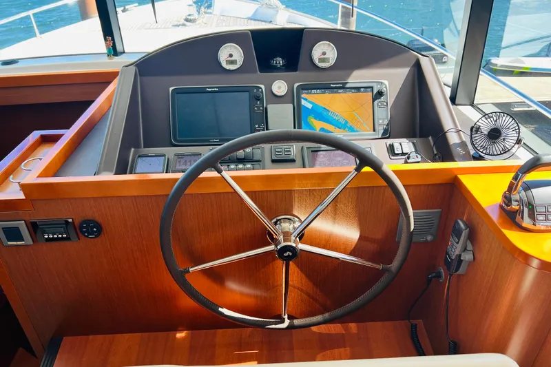 Billy Yacht Photos Pics Helm of 2014 Beneteau Swift Trawler 50 with navigation equipment and steering wheel.