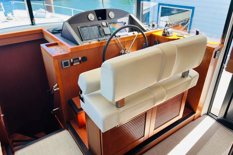 Billy Yacht Photos Pics 2014 Beneteau Swift Trawler 50 helm station with modern controls and leather seating.