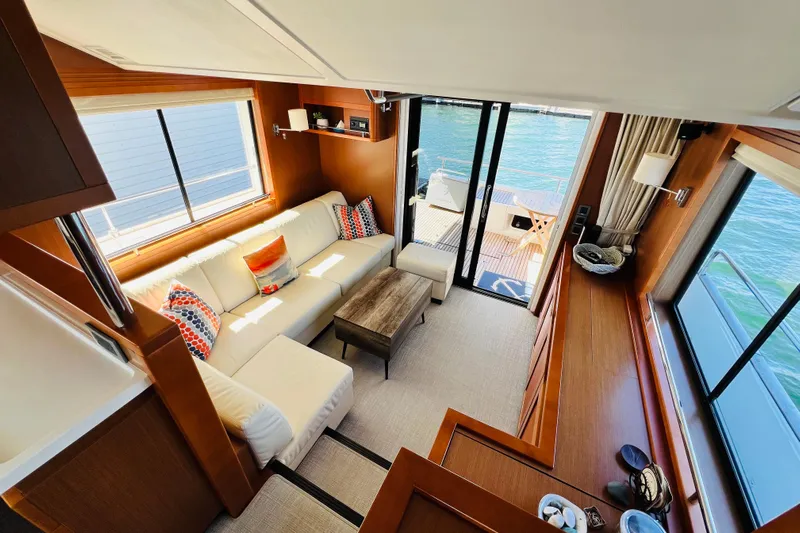 Billy Yacht Photos Pics Luxurious interior of 2014 Beneteau Swift Trawler 50 with elegant seating and waterfront view.