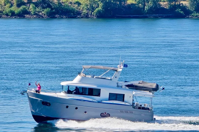 Billy Yacht Photos Pics 2014 Beneteau Swift Trawler 50 cruising on a serene blue lake.