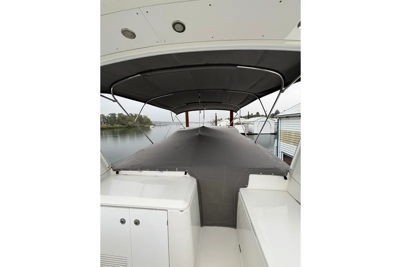 Billy Yacht Photos Pics 2014 Beneteau Swift Trawler 50 with covered deck, docked by calm waters.