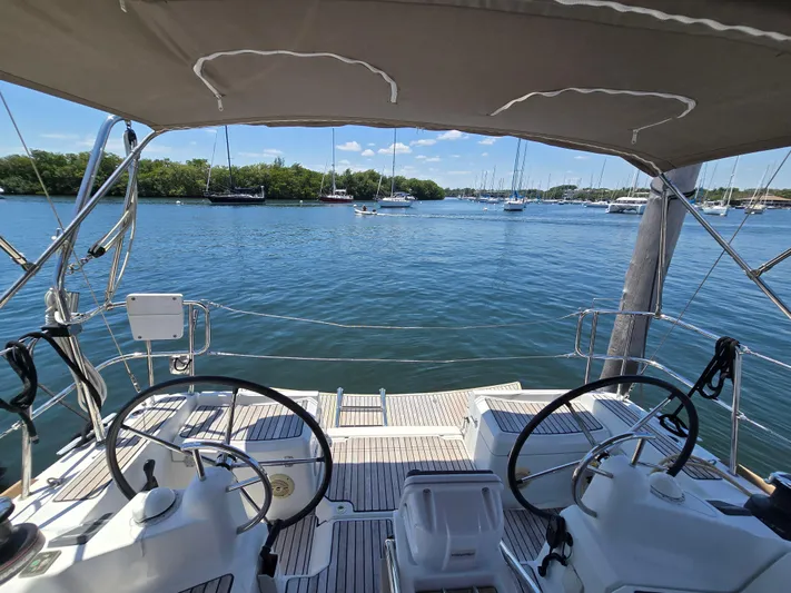  Yacht Photos Pics 2017 Jeanneau Sun Odyssey 389 sailboat cockpit with dual steering wheels on calm water.
