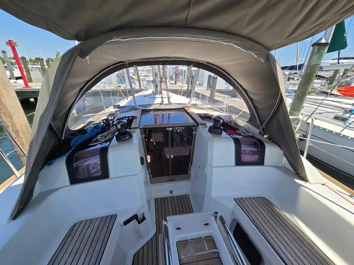  Yacht Photos Pics 2017 Jeanneau Sun Odyssey 389 sailboat cockpit with canopy, docked at marina.