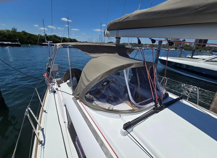  Yacht Photos Pics 2017 Jeanneau Sun Odyssey 389 sailboat docked in a marina under clear blue skies.