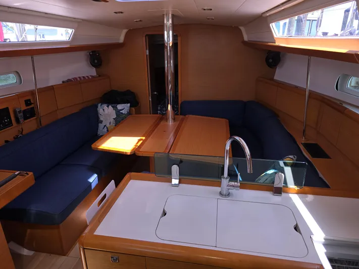  Yacht Photos Pics 2017 Jeanneau Sun Odyssey 389 interior with modern kitchen and cozy seating area.