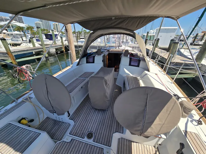  Yacht Photos Pics 2017 Jeanneau Sun Odyssey 389 sailboat cockpit with covered steering wheels at marina.
