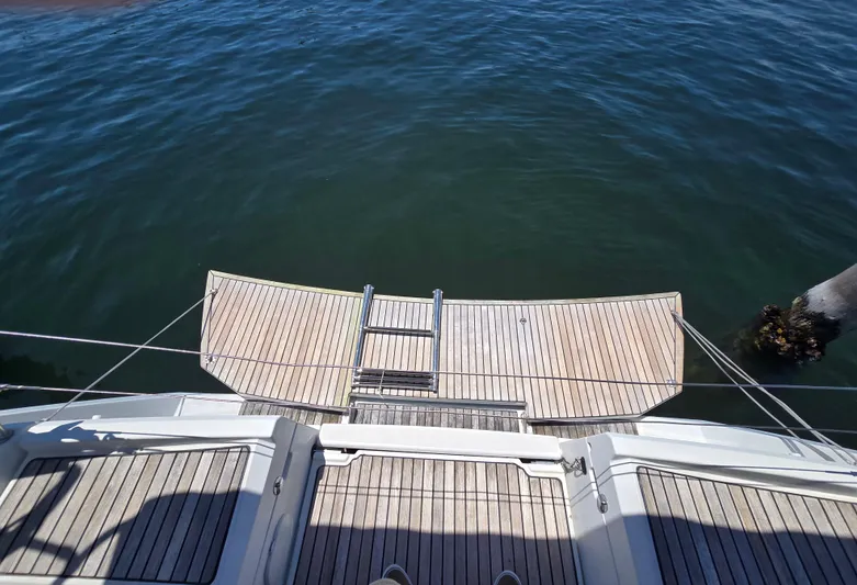  Yacht Photos Pics Jeanneau Sun Odyssey 389 (2017) yacht stern with open swim platform and ladder.